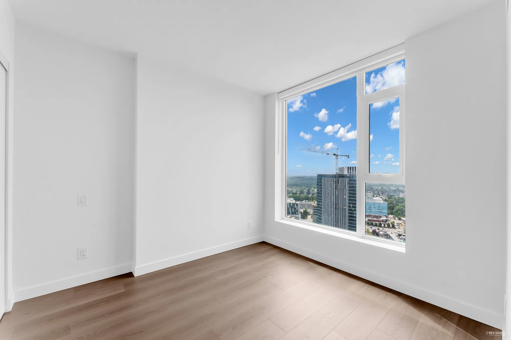 The bedroom with the city to the south through its window
