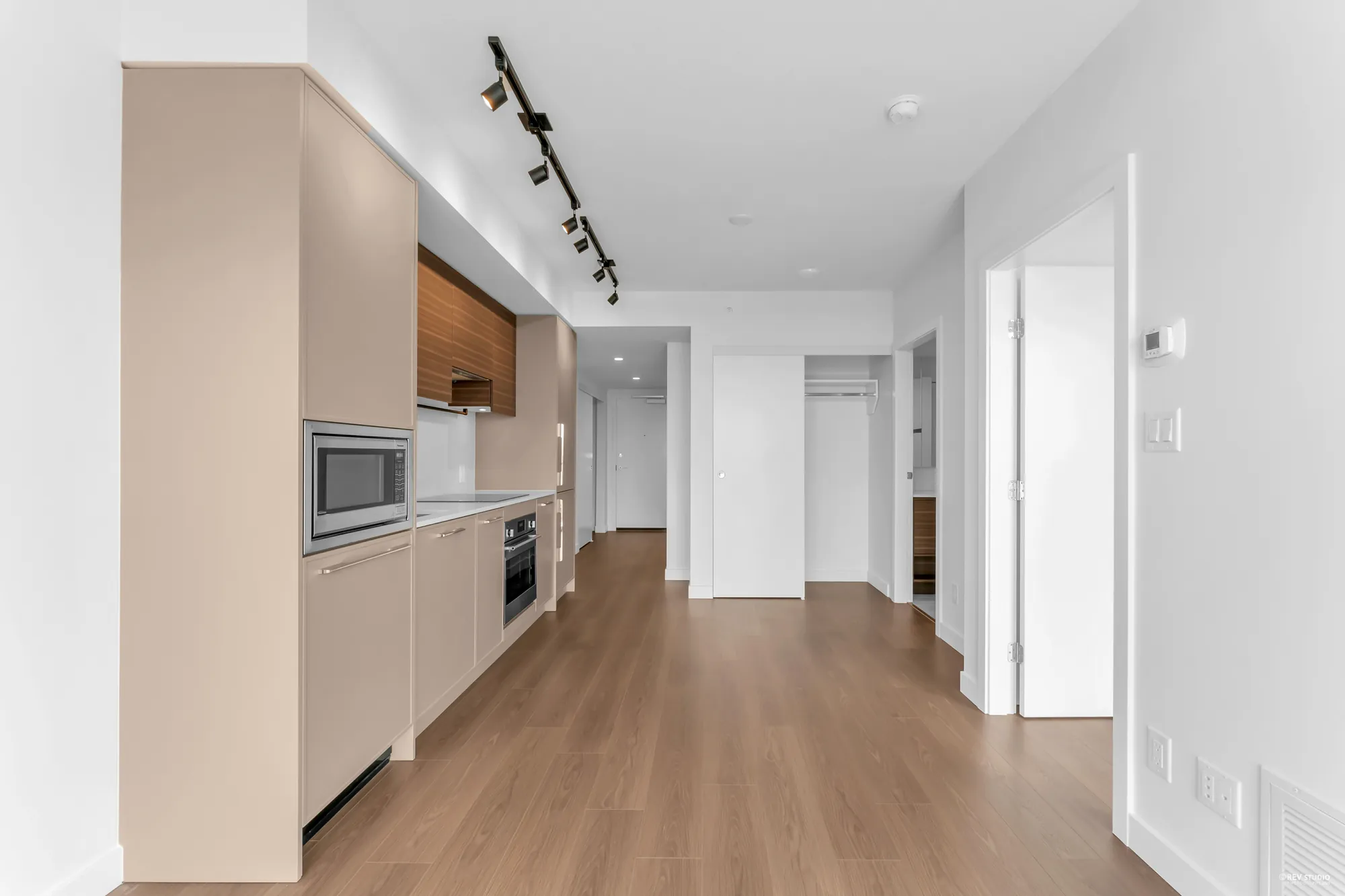 Galley kitchen toward the bedroom and bathroom doors